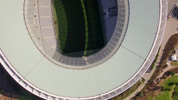 Aerial travel drone view of Cape Town, South Africa with Table Mountain and stadium.