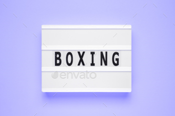 The word boxing on lightbox isolated blue background.