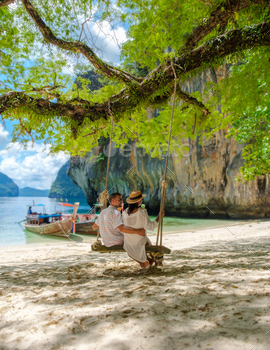 , a couple of European men and an Asian woman on the beach. Couple on a boat trip in Krabi Thailand