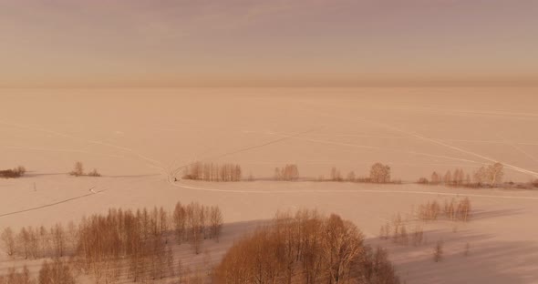 Aerial View of Cold Winter Landscape Arctic Field Trees Covered with Frost Snow Ice River and Sun