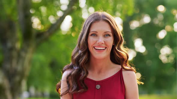 Portrait of Happy Smiling Woman at Summer Park