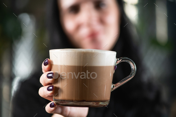 Barista's Hand Holding Crafted Mocha Delight