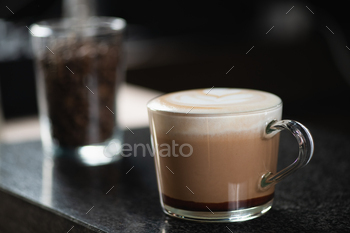 Barista's Hand Holds Mocha Coffee in a Glass Cup