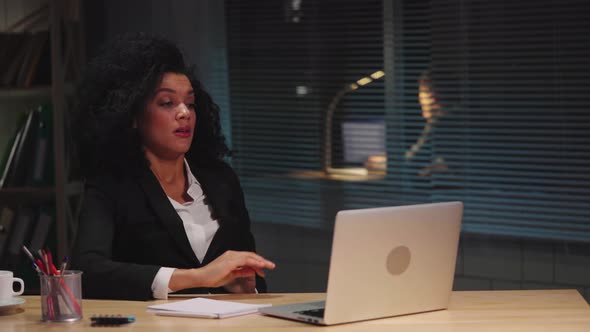 Portrait of African American Woman in Business Suit Suffers From Overwork and Headache