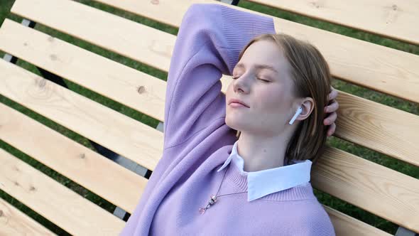 Relaxed Young Woman Blonde in White Wireless Headphones