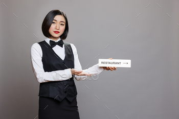 Waitress with restaurant direction sign