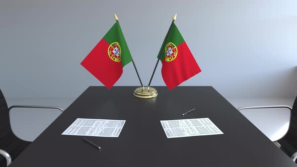 Flags of the Portugal and Papers on the Table