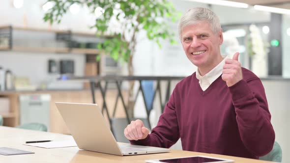 Cheerful Old Businessman with Laptop Showing Thumbs Up