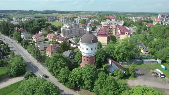 Aerial shot of urban polish landscape with touristic water tower focused. Elk city