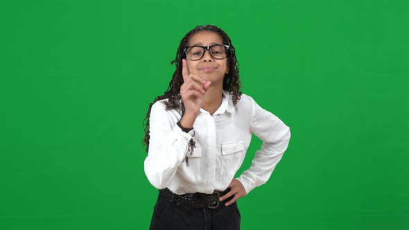 Front View of Adolescent African American Teen Nerd Girl Shaking Finger Gesturing on Green Screen