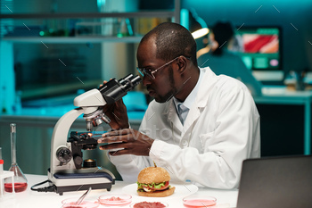 Scientist Looking at Synthetic Meat Through Microscope