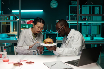 Biracial Scientists Examining Food with Artificial Meat