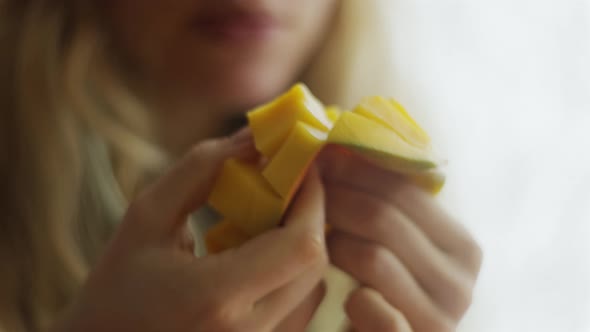 The Girl Cleans Cuts and Eats Mango