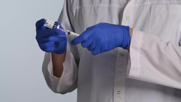 Doctor and Shot for Injection. Physician Prepares Syringe with a Vaccine. An Experienced Medical