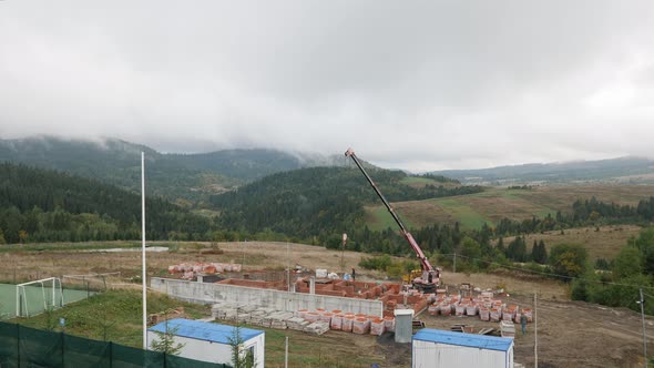 Construction rotating crane on building site of house. Crane working on construction