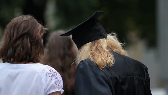 Young Female in Academic Dress and Loving Mother Excited Before Diploma Awarding