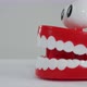 Novelty wind-up teeth chattering to an exit off-screen. - VideoHive Item for Sale
