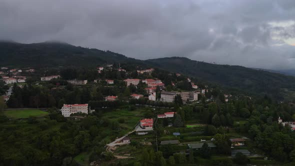 Exterior view of Caramulo Sanatorium and surrounding landscape, Portugal. Aerial forward tilt down