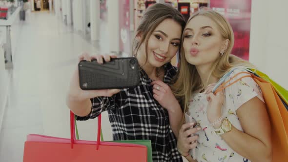 Girls Doing Funny and Happy Faces in Front of Phone Camera in Shopping Mall