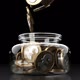 Pound Coins Falling Into Glass Jar Looped - VideoHive Item for Sale