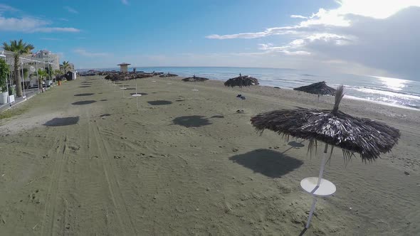 Aerial View Over Sandy Beach with Straw Parasols in Larnaca, Resort Town