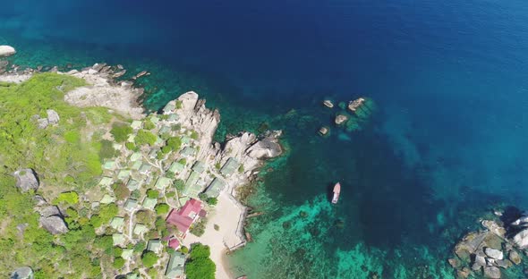 Top Down Thailand's Island Aerial View Mountains and Rocks with Green Forest Lodges and Houses