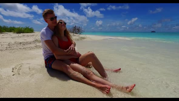 Guy and girl engaged on exotic lagoon beach adventure by blue ocean with bright sandy background of 