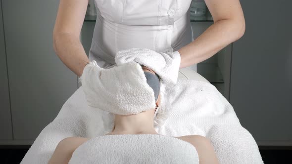 Close-up Shot of Beauty Procedure. Beautician Cleaning Facial Mask. Peeling. Beauty and Body Skin