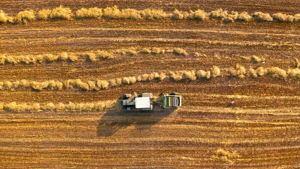 Top view of tractor with round baler on fields