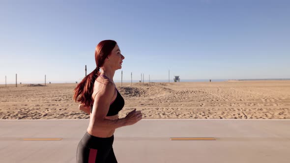 Mature Woman Exercising At The  Beach