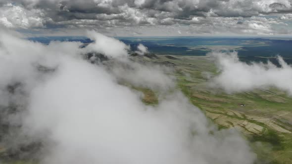 Central Asian Steppes Through Clouds