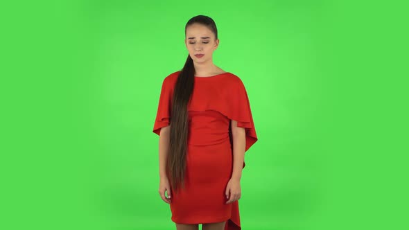 Pretty Young Woman Is Upset Is Shrugging and Sighing. Green Screen