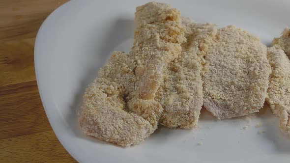 Slider Shot of Chicken Breast Pieces Breaded and Ready to Cook in a Home Kitchen