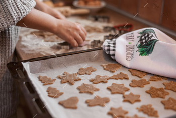 Close up of hands cutting christmas cookies with cookie cutters