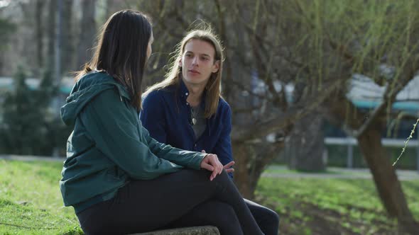 Two people sitting and walking