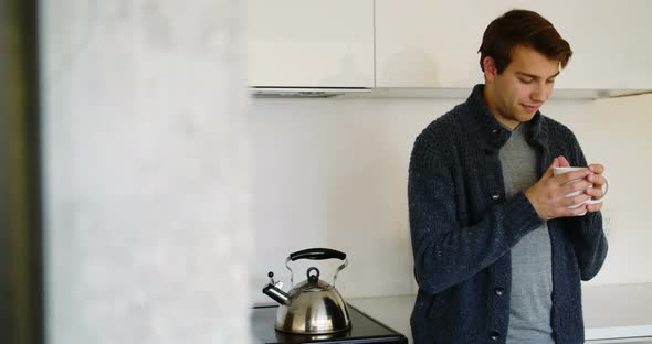 Man having a cup of coffee in kitchen