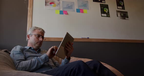 Caucasian man using computer tablet in creative office