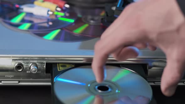 Closeup of Man Ejecting DVD Disc From Player