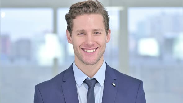 Portrait of Smiling Young Businessman Looking at the Camera 
