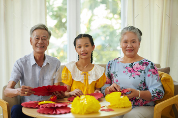 Family Members Making Tet Decorations