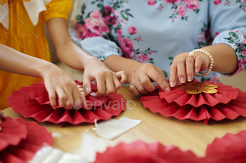 Family Members Making Paper Decorations