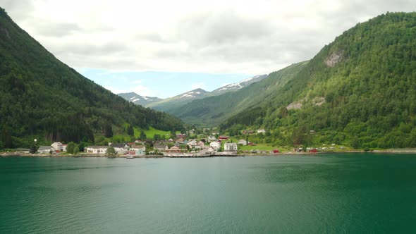 Panorama Of Eidsdal Village With Mountains In Background From Geirangerfjord In Norway. - aerial