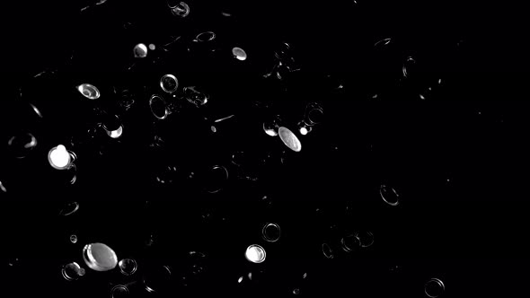 Round silver confetti fly after exploded against black background. 4K 30fps. Slow Motion.