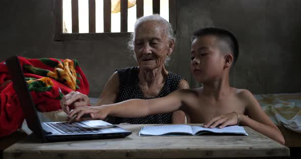 Boy Teaching His Grandmother Use Computer