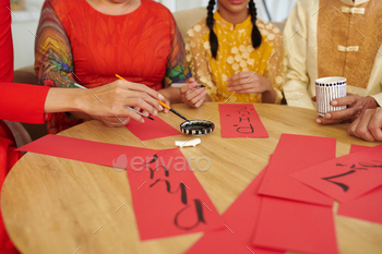 Family Members Writing Calligraphy Couplets