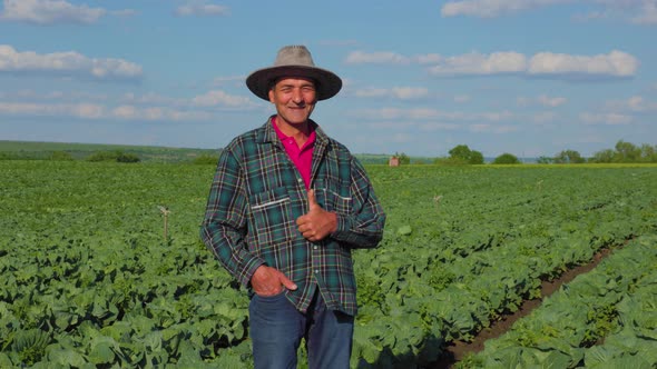 An Old Indian Farmer with His Hand in His Pocket Showing Ok Sign