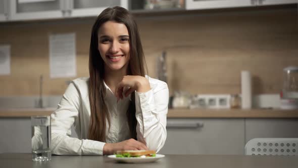 Portrait of Young Gorgeous Business Woman Having Healthy Lunch Break and Eating Sandwich at Kitchen