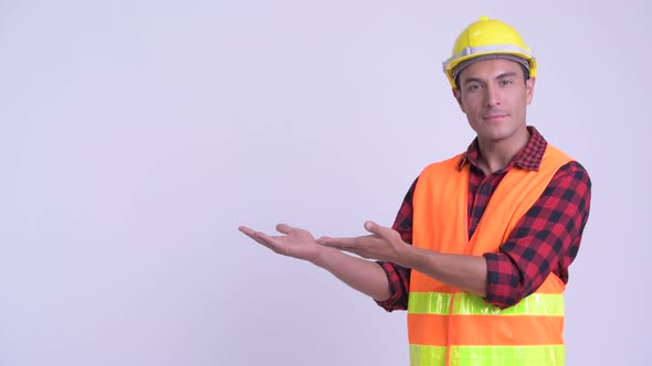 Young Happy Hispanic Man Construction Worker Showing Something
