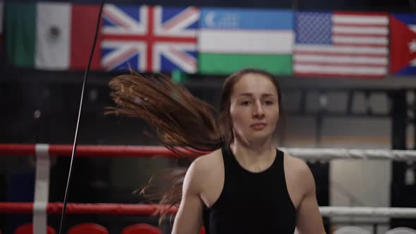 Long Haired Boxer with Her Hands Wrapped in Bandage Jumping on the Skipping