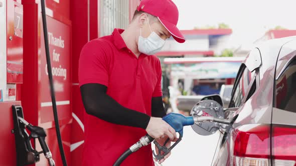 Pumping gas at gas station. Close up of a hand holding fuel